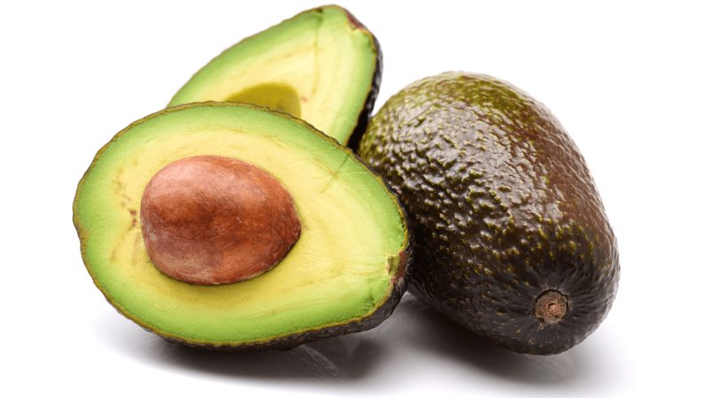 an avocado & a halved avocado on white background