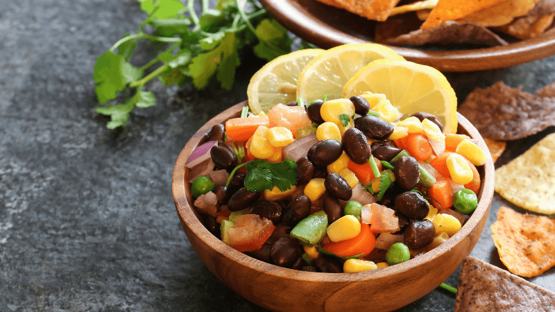a bowl of beans salad on a rustic background