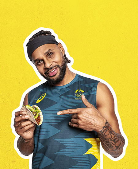 patty mills holding delicious tacos in hand